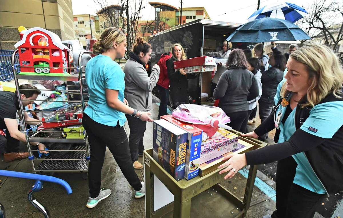 New Haven, Connecticut - Tuesday, December 10, 2019: Yale New Haven Hospital volunteers and friends of "Faith's Toy Drive" of Shelton unload a trailer load of approximately 2100 toys to Yale New Haven Hospital in New Haven Tuesday afternoon for distribution by the YNHCH Auxiliary Toy Closet and the Child Life department. It it's third year, the annual toy drive was started by Faith Tremblay of Shelton, now 16, and her mother Lisa Tremblay.