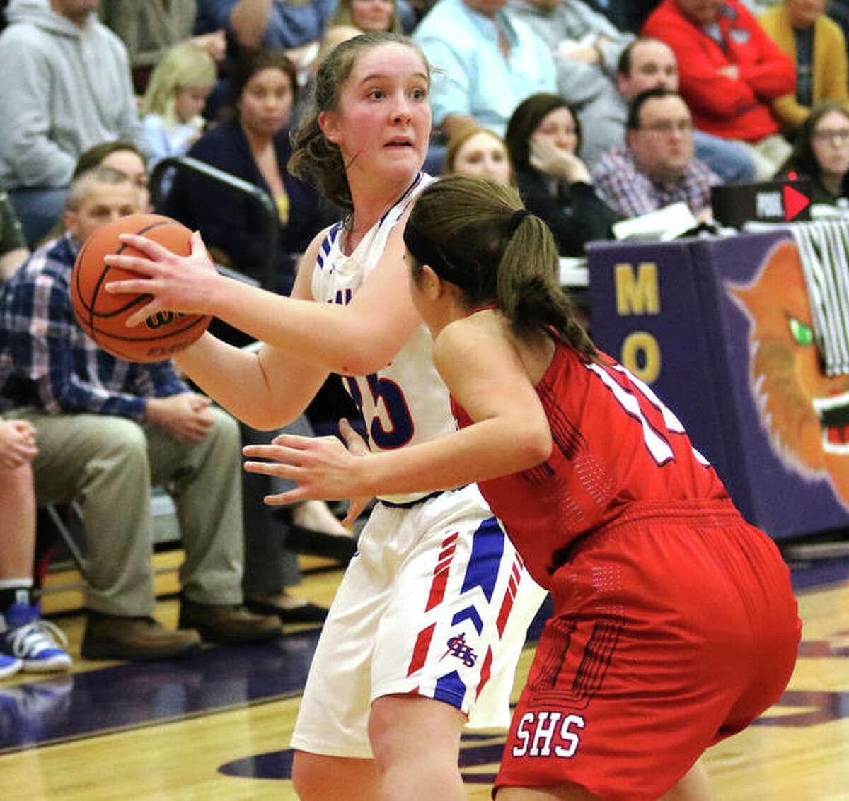 Carlinville’s Sarah DeNeve (left), shown looking for a teammate in a game against Staunton at Mount Olive last season, had 15 points and 10 rebounds Tuesday night in the Cavs’ win over Triad in Carlinville.