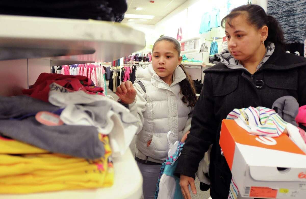 Jennica Gutierrez of East Haven, 10, picks out clothing for herself while shopping with her mother at the Kohl's department store in Branford during the East Haven Rotary Club’s 12th annual "Clothe the Children" campaign in 2012.
