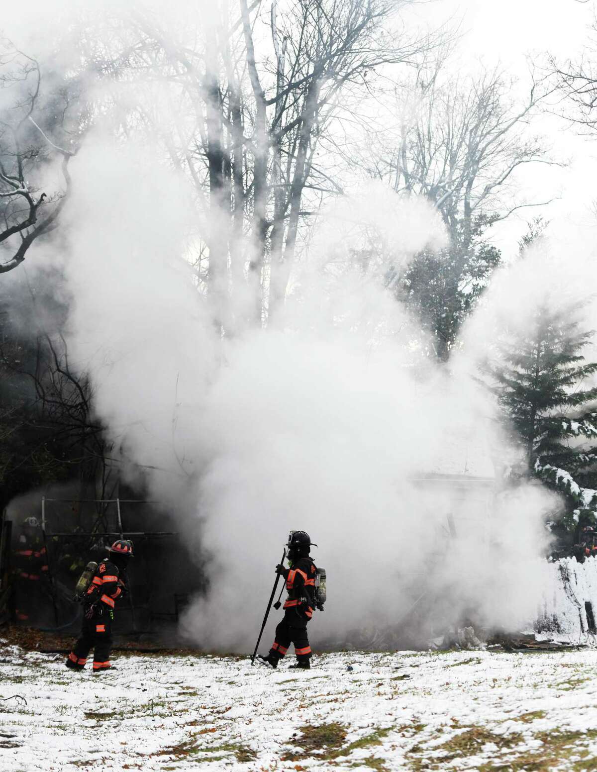 Greenwich firefighters respond to a two-car garage fire on Tomac Court in Old Greenwich, Conn. Wednesday, Dec. 11, 2019. The detached two-car garage was ablaze when firefighters arrived on scene and was extinguished in 19 minutes without any injuries or damage to adjoining structures.