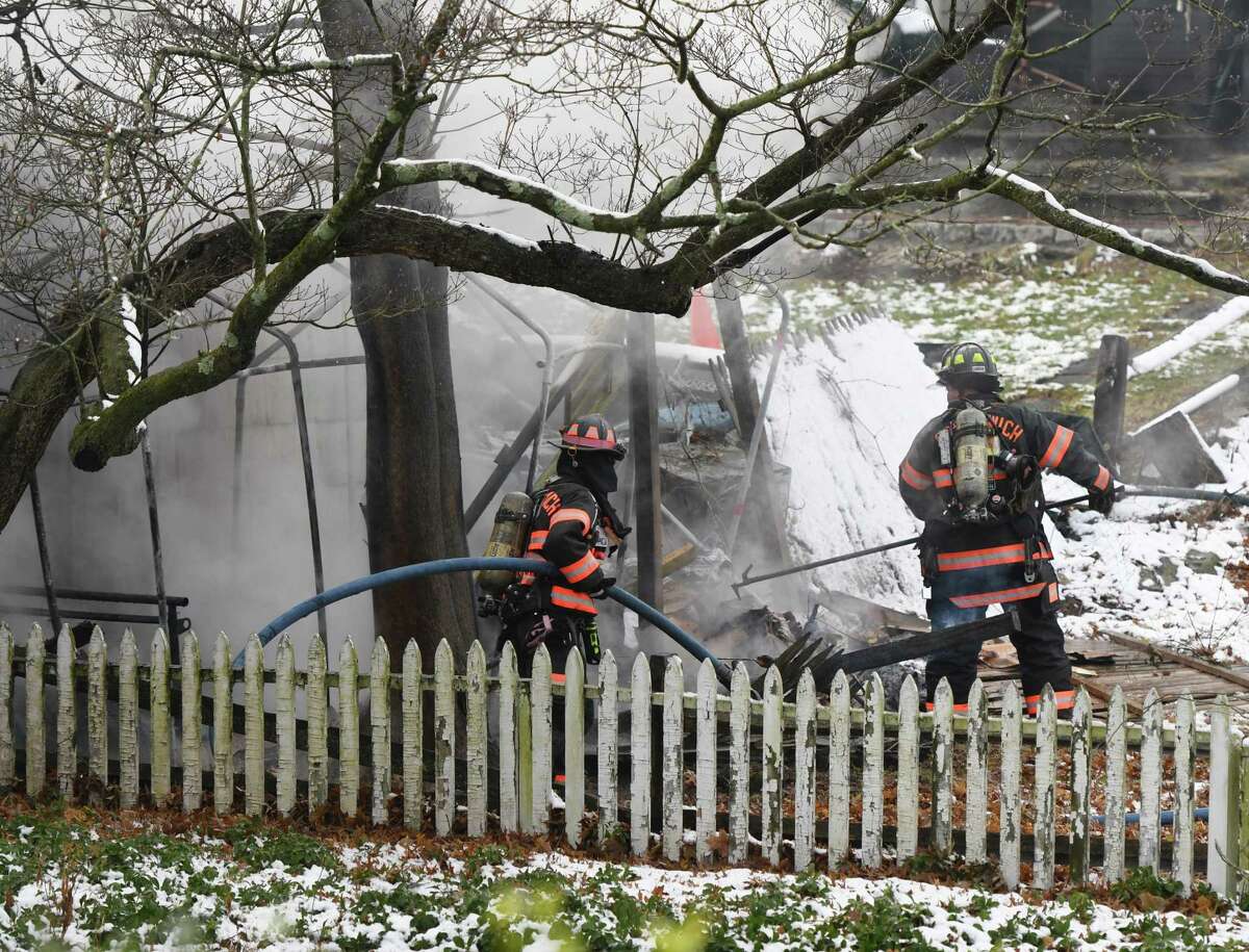 Greenwich firefighters respond to a two-car garage fire on Tomac Court in Old Greenwich, Conn. Wednesday, Dec. 11, 2019. The detached two-car garage was ablaze when firefighters arrived on scene and was extinguished in 19 minutes without any injuries or damage to adjoining structures.