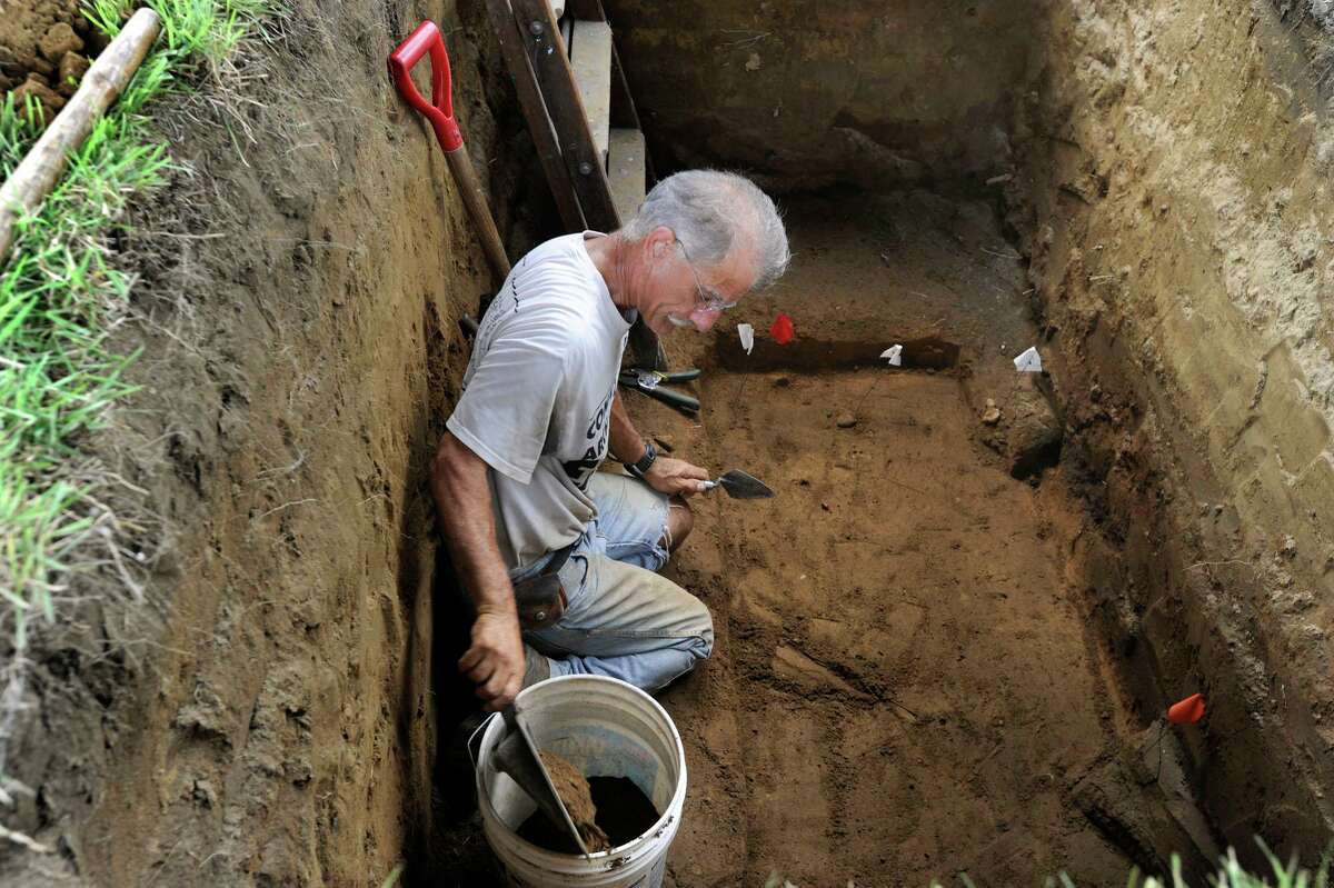 Connecticut State archaeologist Nicholas F. Bellantoni, works in a gravesite at Wooster Cemetary in Danbury, Tuesday, Aug. 14, 2012. Bellantoni is looking for the remains of Albert Afraid of Hawk, a Sioux, who performed with the Buffalo Bill Wild West Show and died in Danbury in 1900.