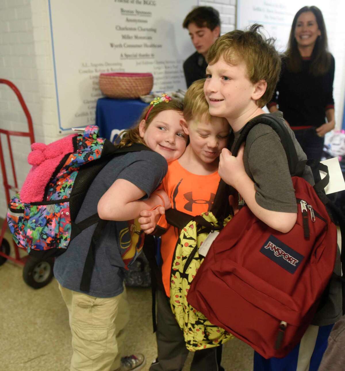 Riverside siblings Rachael Zazula, Joshua Zazula, and Elijah Zazula show their new backpacks at the Filling in the Blanks backpack distribution event at the Boys & Girls Club of Greenwich in Greenwich, Conn. Tuesday, Dec. 10, 2019. The Norwalk-based nonprofit Filling in the Blanks distributed backpacks containing winter hats, gloves, socks, pancake mix, toys, books, and dental items to 100 low-income club members.