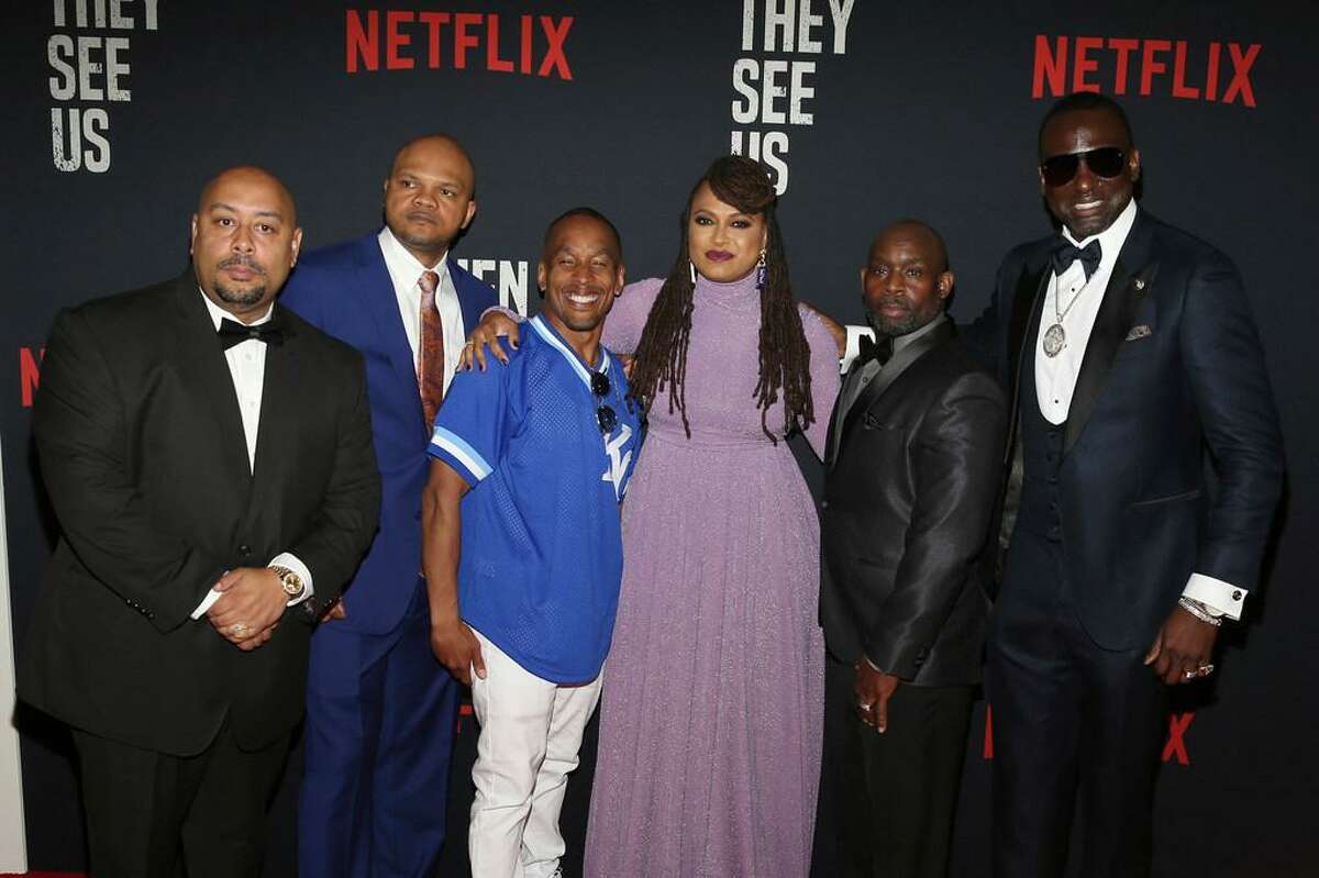 In this May 20, 2019 file photo, Director Ava DuVernay, center, with the Central Park 5: Raymond Santana, from left, Kevin Richardson, Korey Wise, Anthony McCray and Yuesf Salaam, attend the world premiere of "When They See Us," at the Apollo Theater in New York. A former prosecutor in the Central Park Five case has resigned from at least two nonprofit boards as backlash intensified following the release of the Netflix series “When They See Us,” a miniseries that dramatizes the events surrounding the trial.
