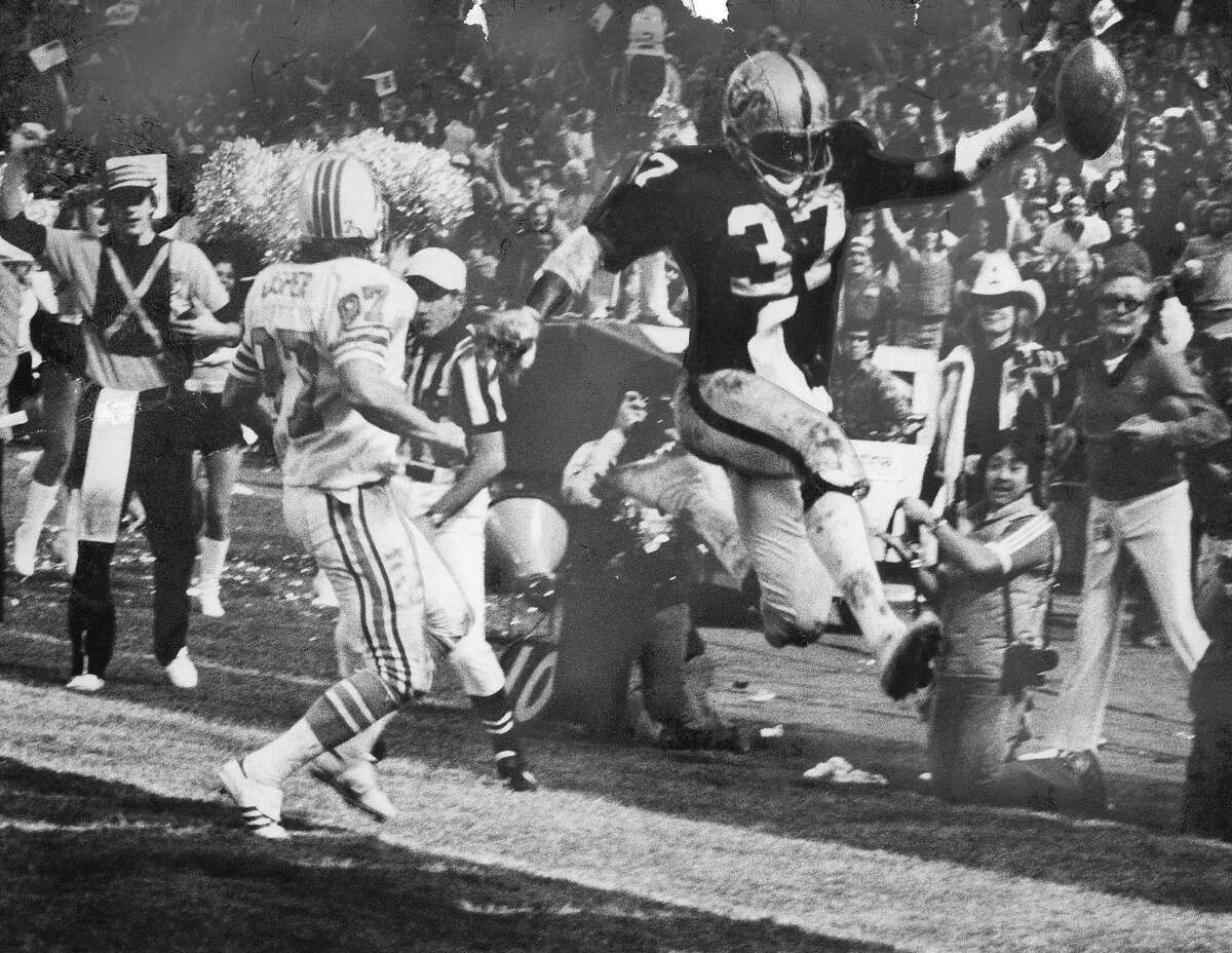 Defensive back Lester Hayes of the Oakland Raiders guards Carlos