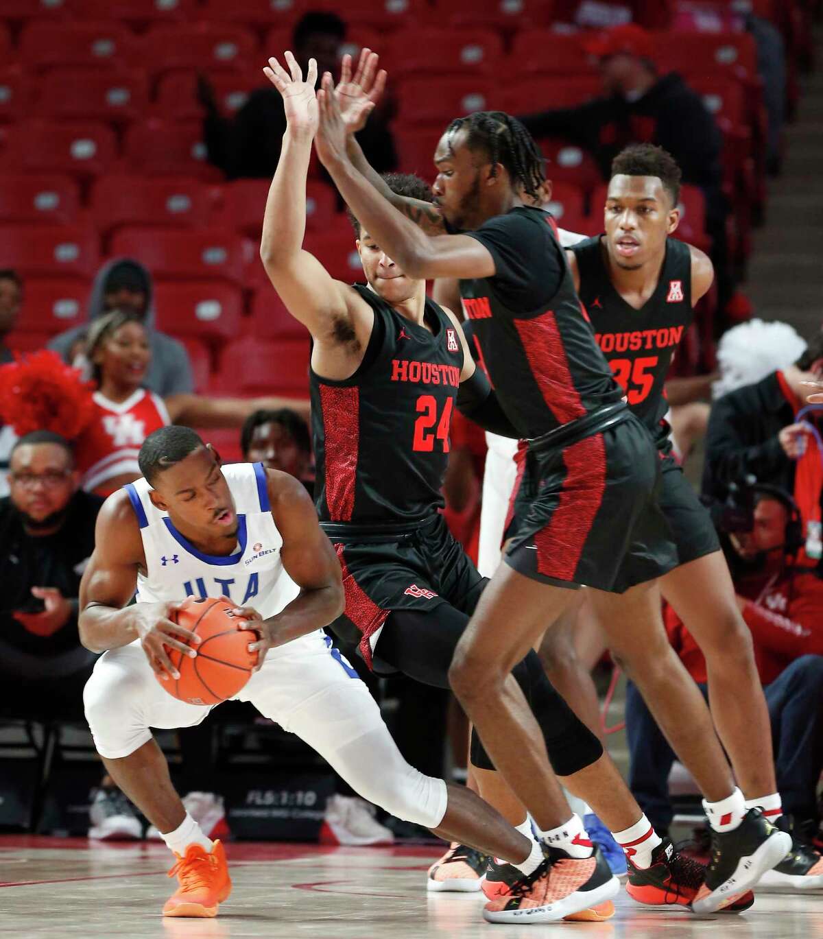 Texas-Arlington Mavericks guard David Azore (4) is met with a Houston Cougars guard Quentin Grimes (24), guard DeJon Jarreau (3) and forward Fabian White Jr. (35) during the first half of an NCAA basketball game at Fertitta Center Wednesday, Dec. 11, 2019, in Houston.
