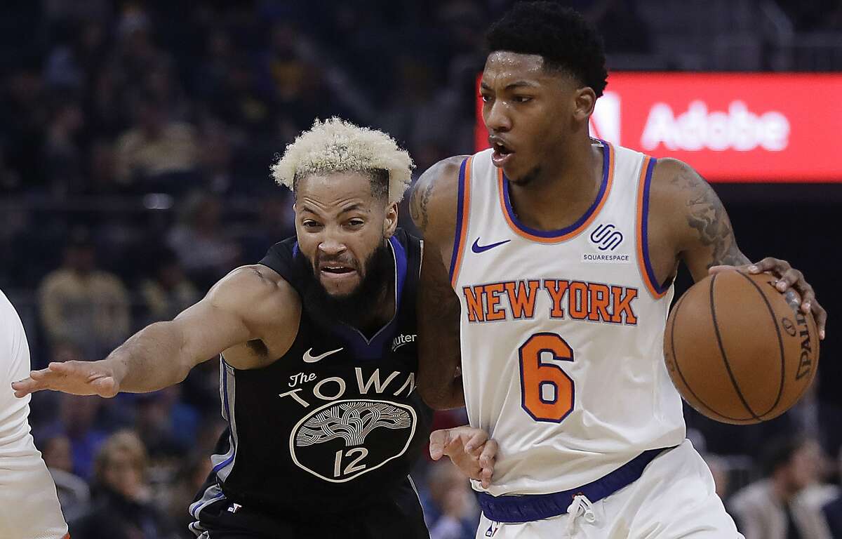 New York Knicks' Elfrid Payton, right, drives the ball against Golden State Warriors' Ky Bowman (12) in the first half of an NBA basketball game, Wednesday, Dec. 11, 2019, in San Francisco. (AP Photo/Ben Margot)