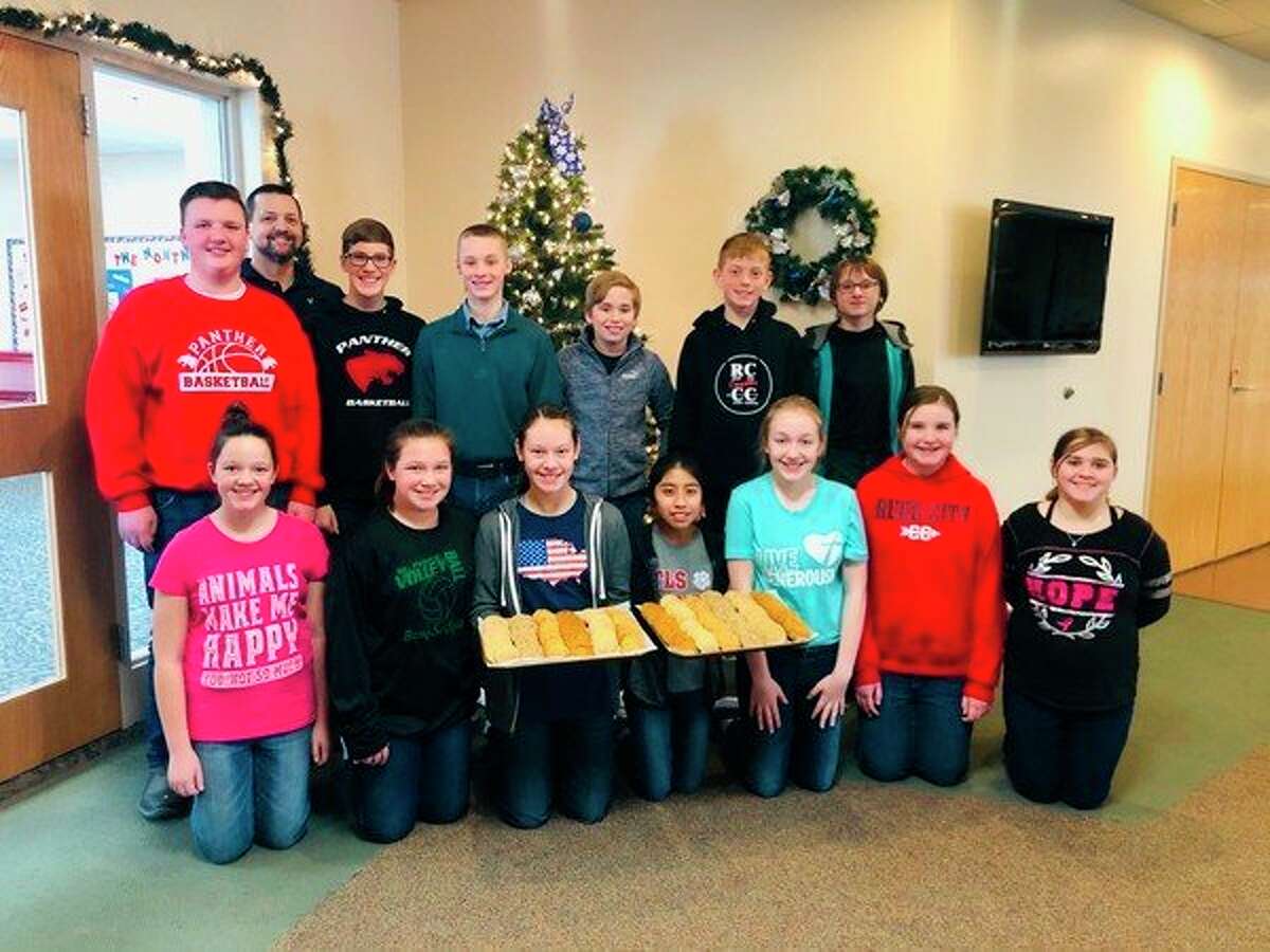 Students from Trinity Lutheran Church and School in Reed City are pictured Wednesday. The students baked more than 700 cookies in anticipation of a cookie walk event, slated for Saturday at the school. (Courtesy photo)