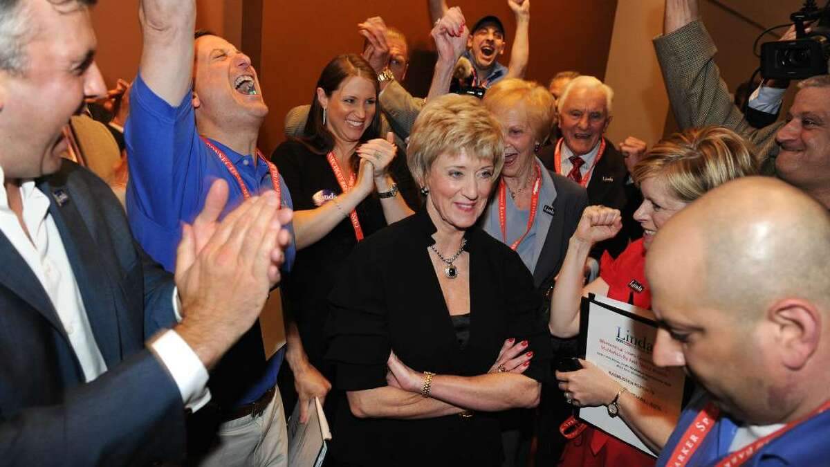 Linda McMahon clinches the nomination for US Senate during the GOP convention in downtown Hartford, Conn. on Friday May 21, 2010. Here, she stands, center, with her campaign manager David Cappiello reacting at left with arm raised, and her son Shane, far left, after learning that she has won the nomination.