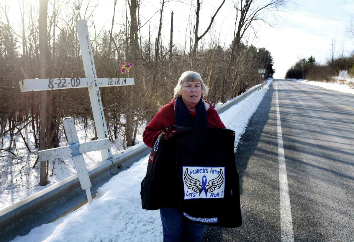 Claire Ansbro-Ingalls, member of Kenneth’s Army, a child victim advocacy group formed following the death of Kenneth White, 5, in 2014, stands next to a memorial placed at the fatal site where White's body was found on Thursday, Dec. 12, 2019, in Knox, N.Y. The group works quietly in Albany County's hilltowns to provide necessities for children in need. White was killed by teenage cousin, Tiffany VanAlstyne, and dumped across the road in a snowbank. (Will Waldron/Times Union)