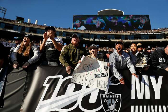 Oakland Raiders fans dressed in costumes arrive at the Oakland