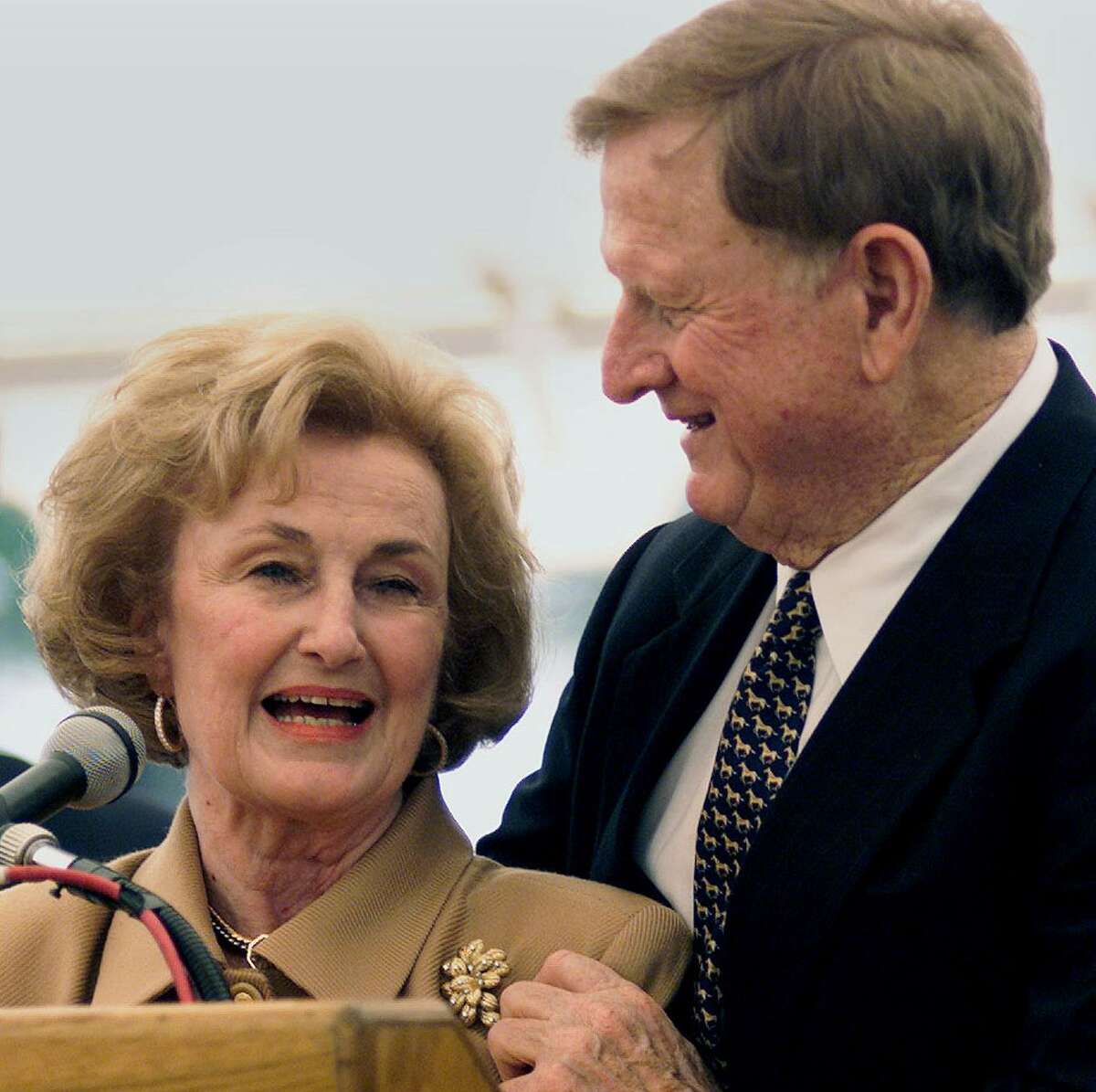 Red McCombs embraces his wife Charline as the two appear at ceremonies marking the dedication of the McCombs School of Business at the University of Texas in Austin on October 26, 2001.