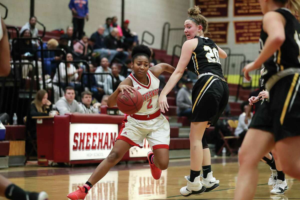April Artis (2) of Wilbur Cross makes a move around Hand's Summer Adams (20) during a game between Daniel Hand Tigers Girls Varsity Basketball and Wilbur Cross Lady Governors Girls Varsity Basketball on February 16, 2019 at Mark T. Sheehan High School in Wallingford, CT.