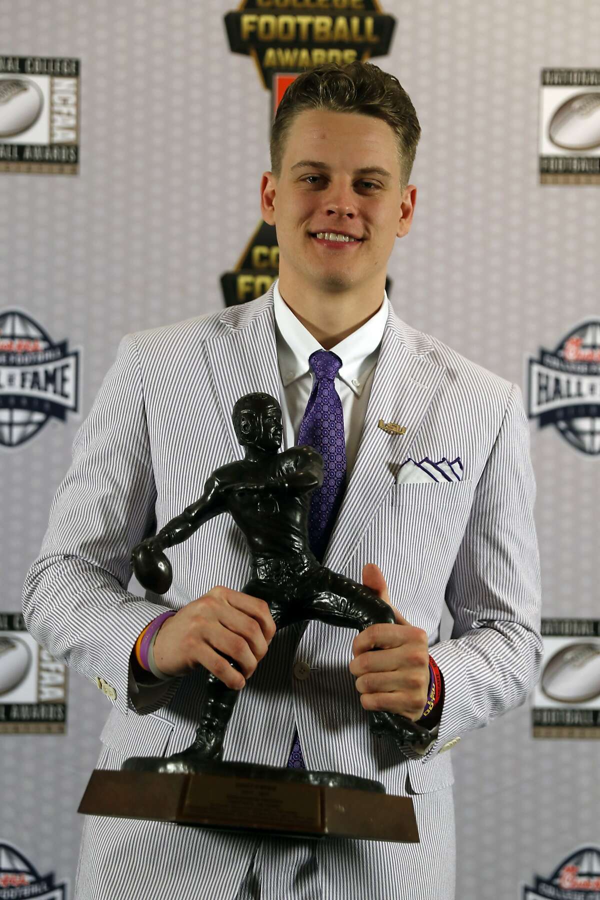 LSU quarterback Joe Burrow poses with trophy after winning the Davey O'Brien Award for being the nation's best quarterback Thursday, Dec. 12, 2019, in Atlanta. (AP Photo/John Bazemore)