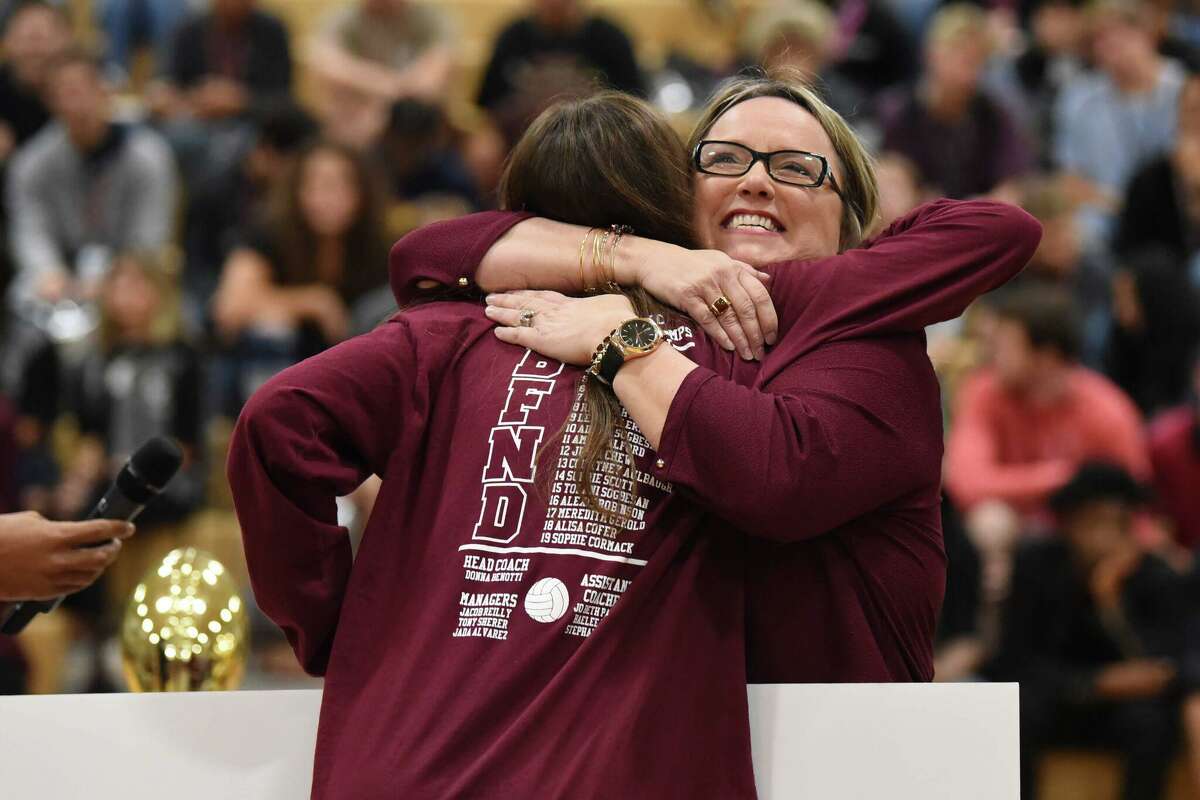 Sophie Scott, a senior at Cy-Fair High School, gets a hug from her volleyball coach Donna Benotti, who nominated her for a $10,000 scholarship through Reliant Energy's Scholarship for Champions program. Scott was announced as the recipient during a pep rally at her school on Nov. 20, 2019.