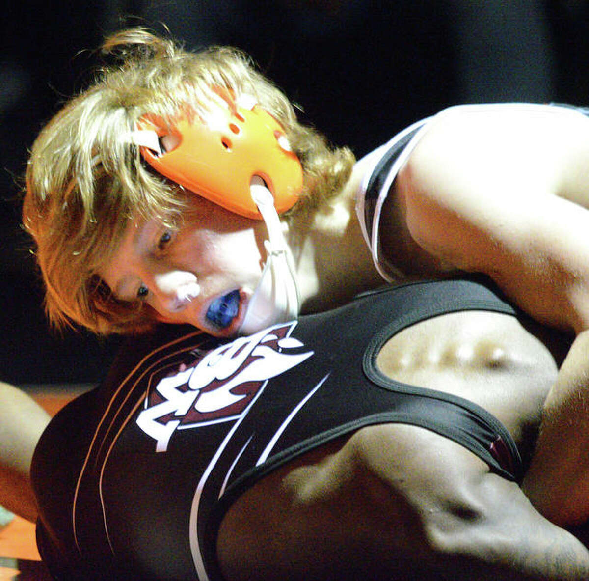 Edwardsville’s Jack Summers, top, tries to get a grip on Belleville West’s Justin Harris at 106 pounds during Thursday’s Southwestern Conference dual match at Jon Davis Wrestling Center.