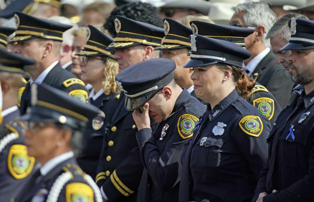 A Houston Police Officer wipes away tears during a funeral service for Houston Police Sgt. Christopher Brewster, Thursday, Dec. 12, 2019, at Grace Church Houston in Houston. Brewster, 32, was gunned down Saturday evening, Dec. 7, while responding to a domestic violence call in Magnolia Park. Police arrested 25-year-old Arturo Solis that night in the shooting death. Solis faces capital murder charges. (AP Photo/David J. Phillip)
