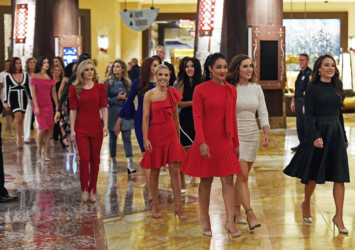 The 51 candidates for Miss America 2020 walk through the lobby of the Mohegan Sun hotel as they arrive for the formal Arrival Ceremony for the Miss America 2.0 competition Thursday, Dec. 12, 2019 at Mohegan Sun. The annual competition, in its 99th year, moved from Atlantic to Mohegan Sun this year. The candidates will face a series of preliminary competitions over the coming week culminating in the final competition on live TV next Thursday. (Sean D. Elliot/The Day via AP)