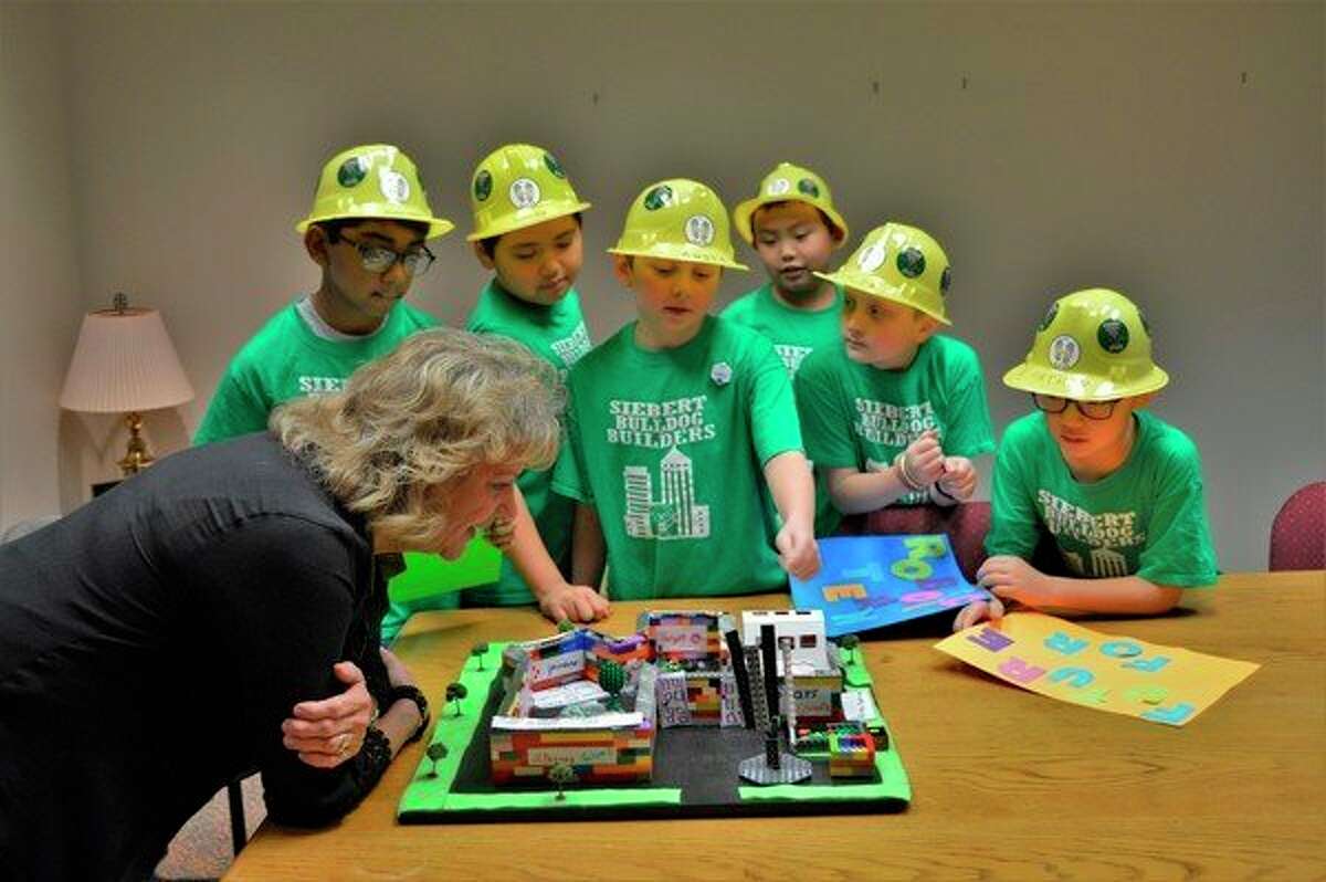 The Siebert Bulldog Builders robotics team presents their ideas for the Midland Mall to Manager Lori Snyder this week at the Midland Mall. (Ashley Schafer/Ashley.Schafer@hearstnp.com)