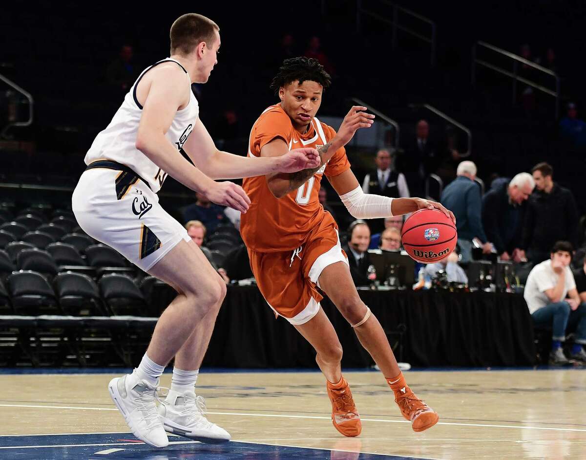 NEW YORK, NEW YORK - NOVEMBER 22: Gerald Liddell #0 of the Texas Longhorns drives past Grant Anticevich #15 of the California Golden Bears during the first half of their game at Madison Square Garden on November 22, 2019 in New York City.