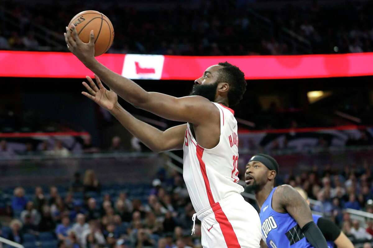 James Harden gets past Orlando’s Terrence Ross for a layup in Friday’s win. Harden hit 10-of-15 from long range and finished with 54 points, going over 50 for the fourth time in his past seven games.