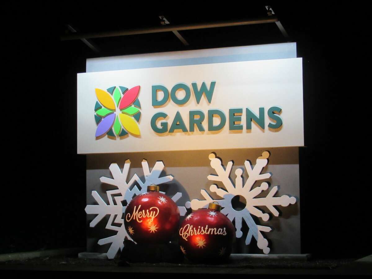 Visitors walk along lighted paths and enjoy the holiday sights and sounds at Dow Gardens' annual Christmas Walk on Friday, Dec. 13.