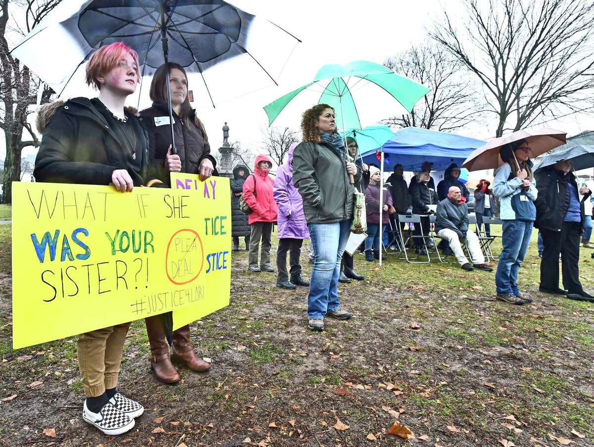 Milford, Connecticut - Saturday, December 14, 2019: Grace Weir, 14, left, and her mother Wanda Hittinger, second from left, both of West Haven, stand in support of Lori Wierzbicki (CQ), 50, of Milford, who was brutally beaten by a neighbor who has been offered a lenient plea bargain, during a protest rally Saturday afternoon on the Milford Green