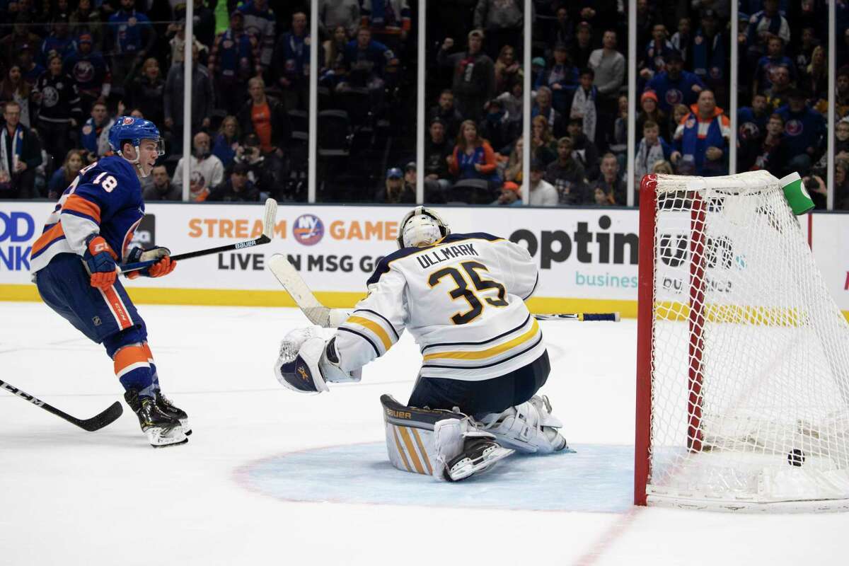 New York Islanders left wing Anthony Beauvillier (18) beats Buffalo Sabres goaltender Linus Ullmark (35) with an overtime goal in an NHL hockey game, Saturday, Dec. 14, 2019 in Uniondale, N.Y. The Islanders won 3-2. (AP Photo/Mark Lennihan)
