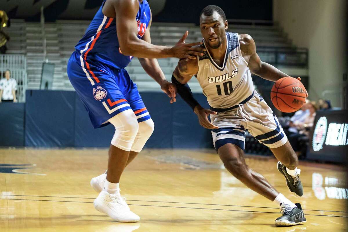 Rice guard Robert Martin (10) drives past Houston Baptist forward Benjamin Uloko (32) in the second half of a college basketball game Saturday, Dec 14, 2019, in Houston.