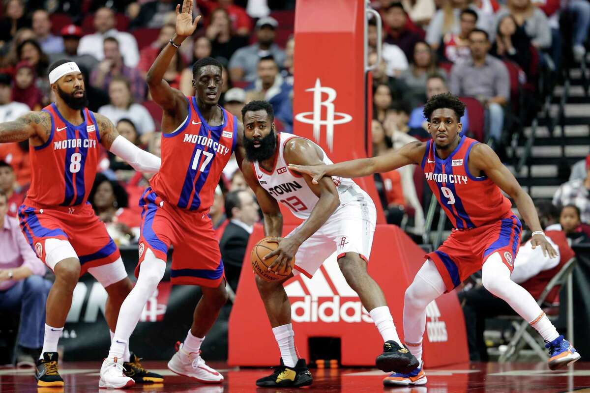 Houston Rockets guard James Harden (13) searches to pass the ball from between Detroit Pistons forward Markieff Morris (8), guard Tony Snell (17) and guard Langston Galloway (9) during the first half of an NBA basketball game Saturday, Dec. 14, 2019, in Houston. (AP Photo/Michael Wyke)