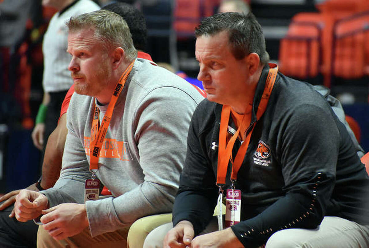 Edwardsville head coach Jon Wagner, right, and assistant coach Doug Heinz watch intently as Lloyd Reynolds wrestles in a consolation match at last year’s Class 3A state tournament in Champaign.