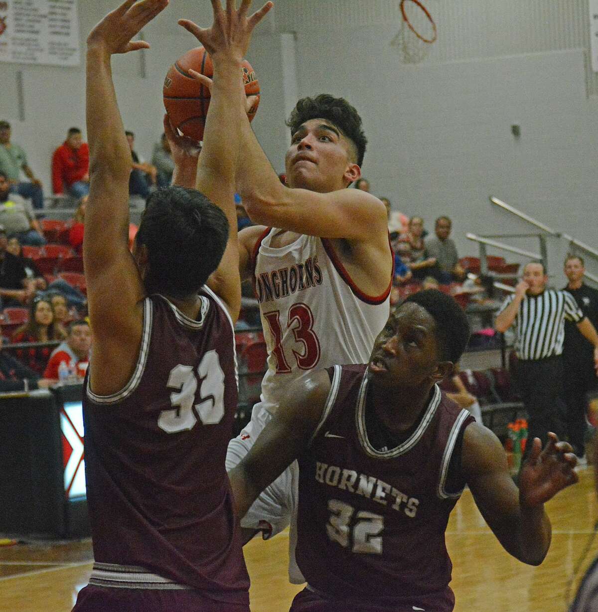 Lockney’s Noel Ceniceros puts up the shot while being defended by Tulia players Alan Garcia (33) and Mitchell Roberts during their boys basketball game in the Longhorn Shootout at Lockney High School on Friday night.
