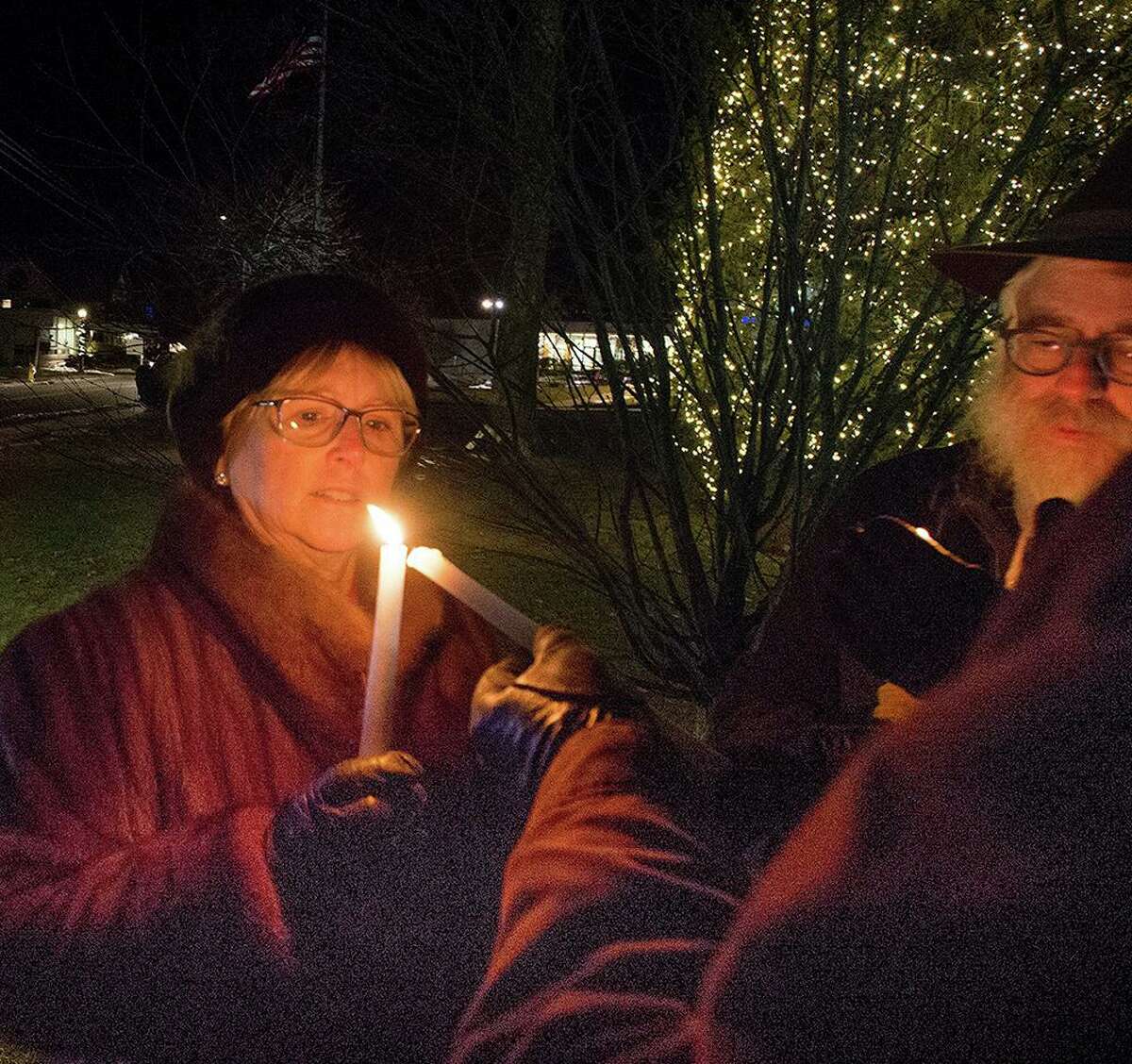 First Selectwoman Lynn Vanderslice holds a shamash which will helps light the menorah last year. This year's menorah lighting celebration is Dec. 22 at 5 p.m. on the town green.