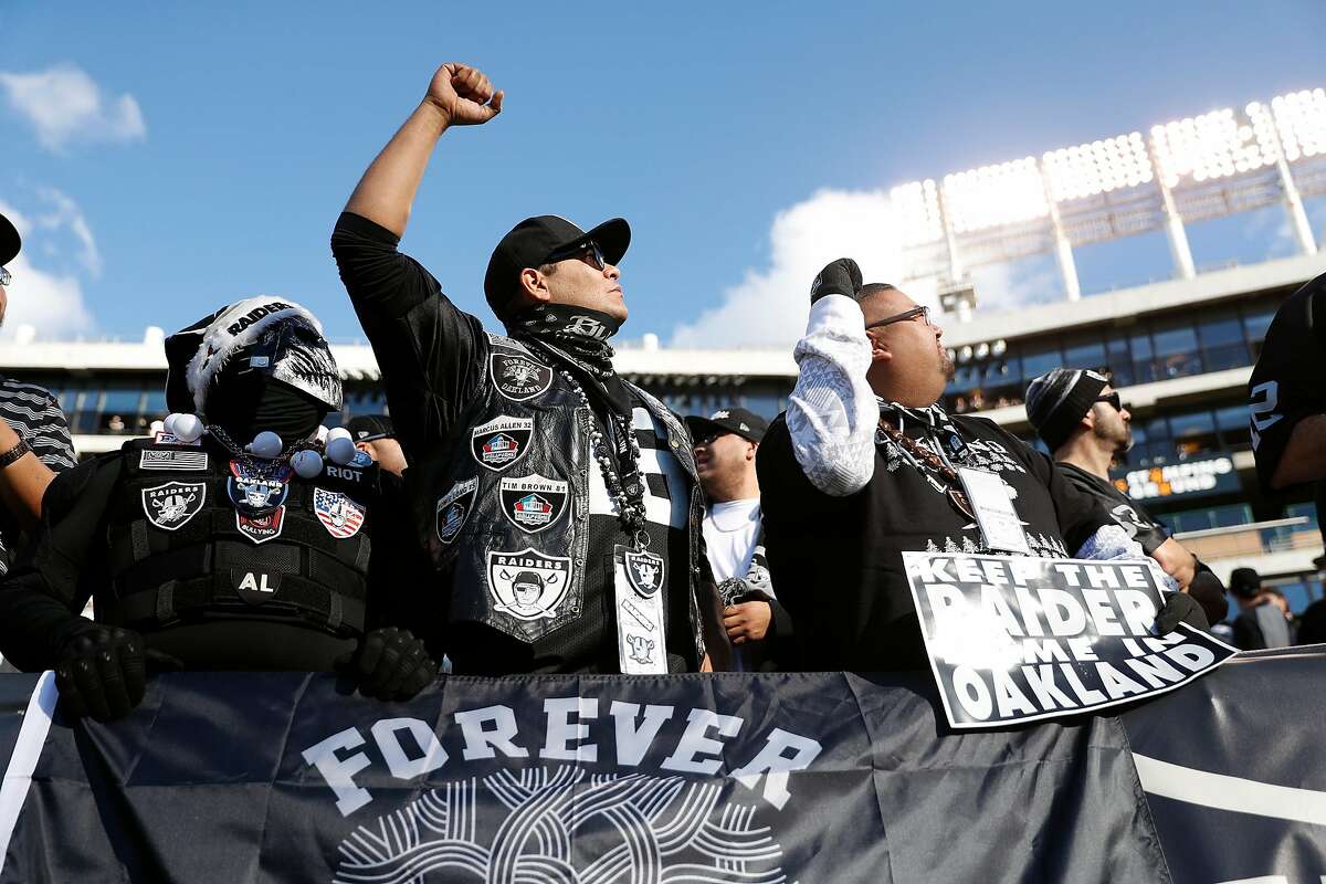 Oakland Raiders' fan Jose Lopez (center) reacts as Raiders' Hall of Famer Jim Otto addresses the crowd during Raiders final home game at Oakland Coliseum in Oakland, Calif., on Sunday, December 15, 2019.