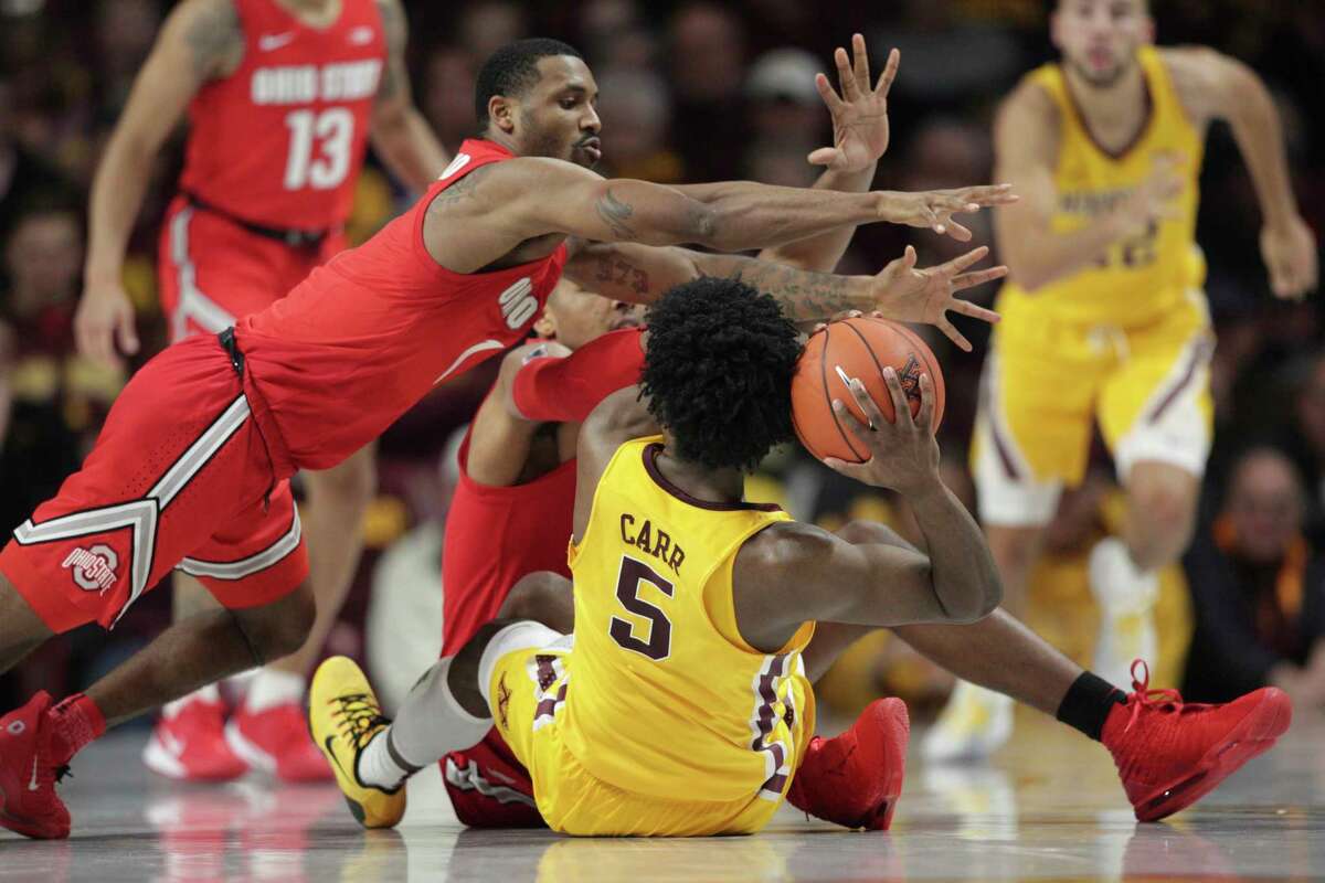 Minnesota guard Marcus Carr (5) looks to pass as Ohio State guard Luther Muhammad (1) and forward Andre Wesson (24) dive in during the second half in an NCAA college basketball game Sunday, Dec. 15, 2019, in Minneapolis. (AP Photo/Andy Clayton-King)