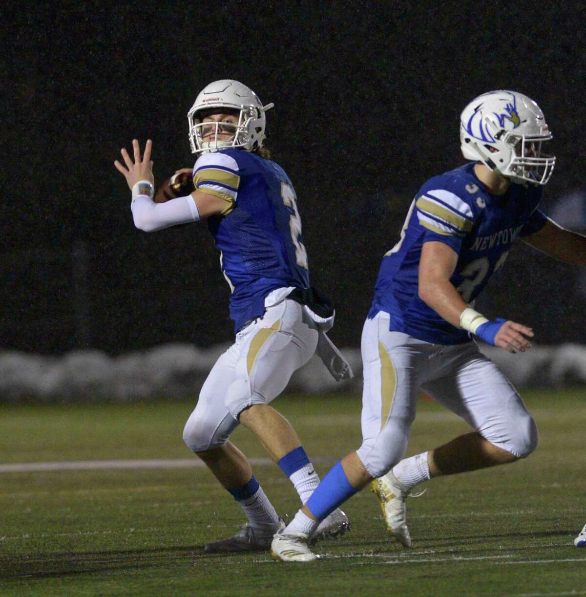 Newtown quarterback John Street looks to pass in the Class LL State Football semifinal game between No 4 Simsbury and No. 1 Newtown high schools, Monday December 9, 2019, at Newtown High School, Newtown, Conn.