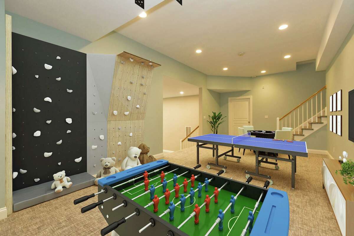 On the Market Contemporary home features pool, rock climbing walls