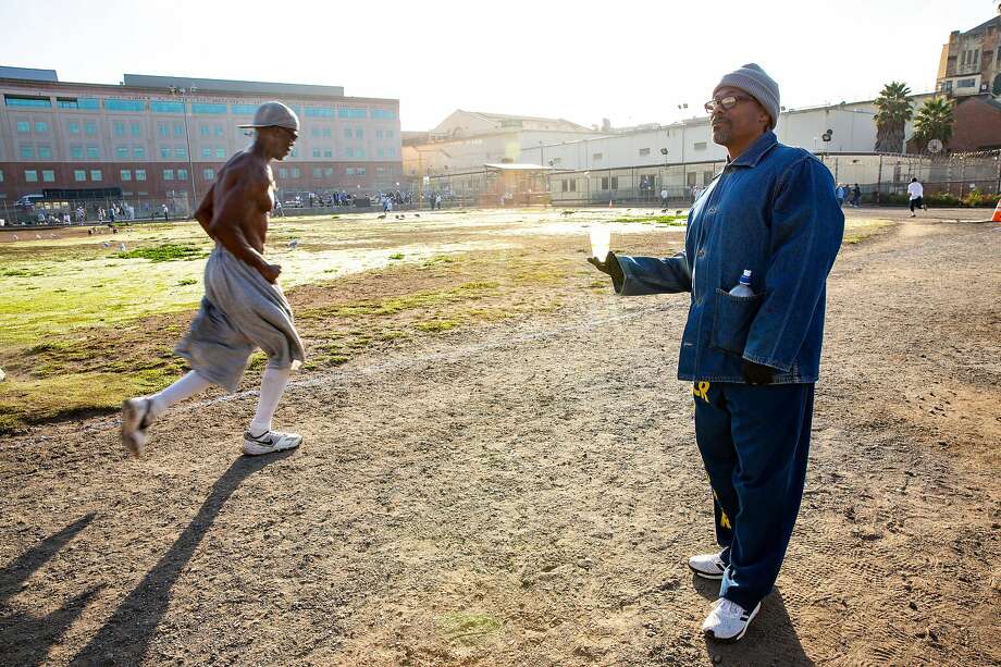 Clifton Williams hands out waters as Wallace Jackson completes another lap around the prison yard in the San Quentin State Prison marathon on Friday, Nov. 22, 2019, in San Quentin, Calif. Photo: Santiago Mejia / The Chronicle