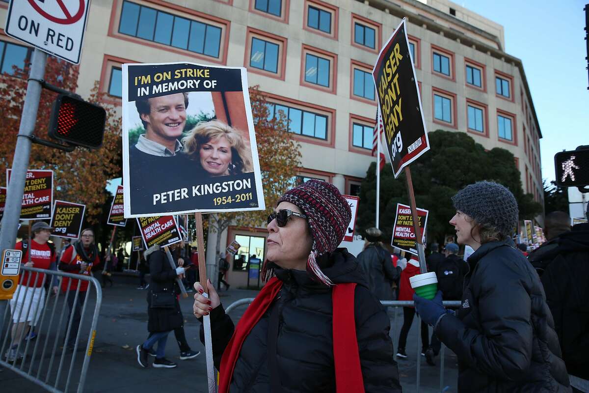 Christine Messinger, Kaiser therapist and bargaining committee member, pickets with other members of the National Union of Healthcare Workers on Geary Boulevard outside Kaiser Permanente San Francisco Medical Center on Monday, December 16, 2019 in San Francisco, Calif.