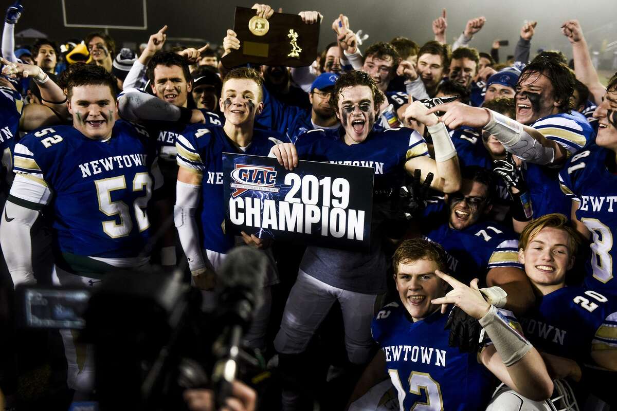 The Newtown Nighthawks celebrate their win after beating the Darien Blue Wave in the final play of the Class LL state football championship at Trumbull High School Saturday, Dec. 14, 2019, in Trumbull. Newtown won 13-7. (Kassi Jackson/Hartford Courant/TNS)