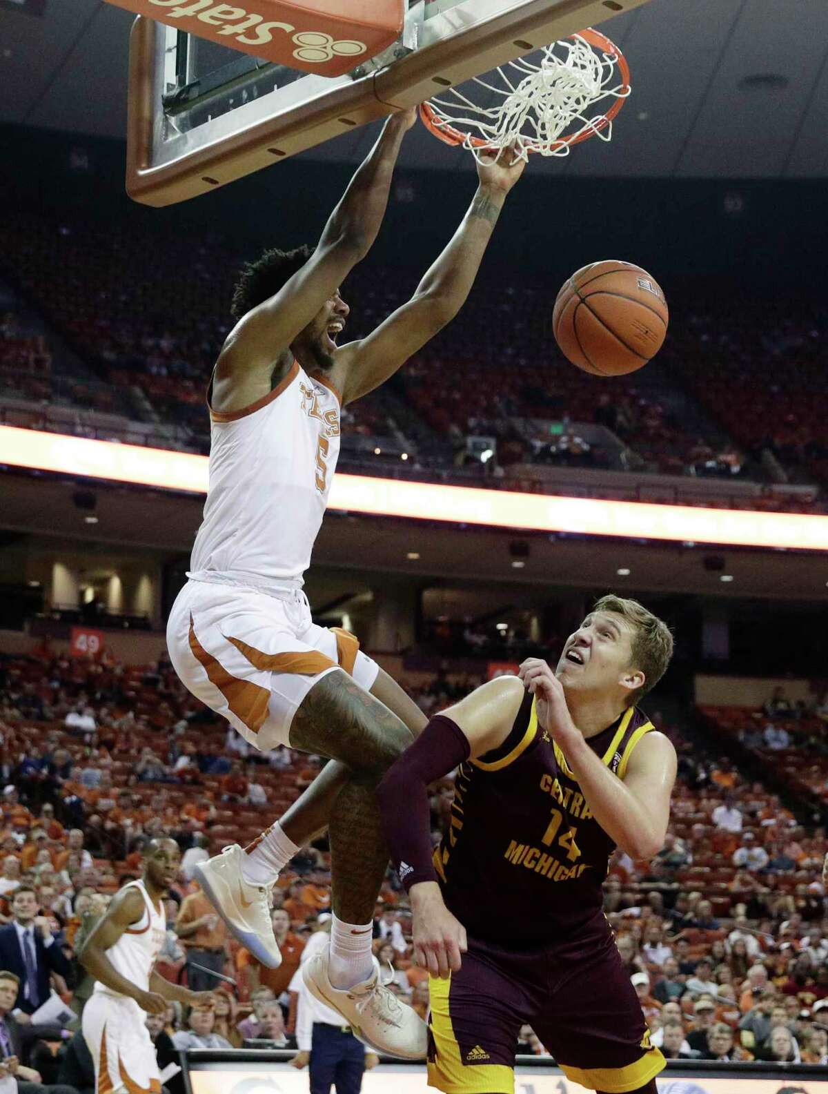 Texas forward Royce Hamm Jr. (5) scores over Central Michigan forward David DiLeo (14) during the second half of an NCAA college basketball game, Saturday, Dec. 14, 2019, in Austin, Texas. (AP Photo/Eric Gay)