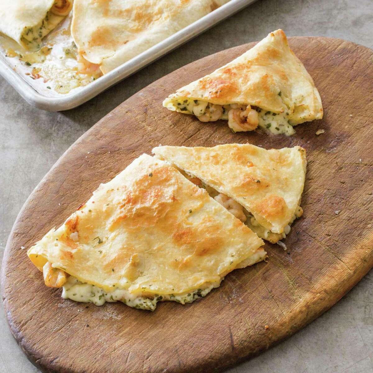 This undated photo provided by America's Test Kitchen in June 2019 shows Tequila-Lime Shrimp Quesadillas in Brookline, Mass. This recipe appears in the cookbook "New Essentials." (Carl Tremblay/America's Test Kitchen via AP)