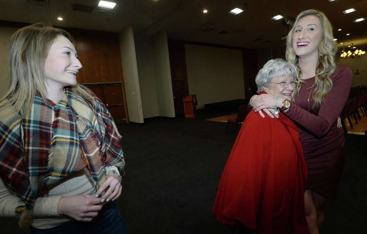 Maci Charpiot looks on as sister Brooke Charpiot, a volleyball honoree from East Chambers hugs her grandmother Mary Robert following the award presentations of the annual Super Gold fall sports banquet at the MCM Elegante Hotel Monday night. The event, sponsored by MId County Chrysler Dodge Jeep Ram Fiat, honors star athletes and coaches from the fall sports season. Photo taken Monday, December 16, 2019 Kim Brent/The Enterprise