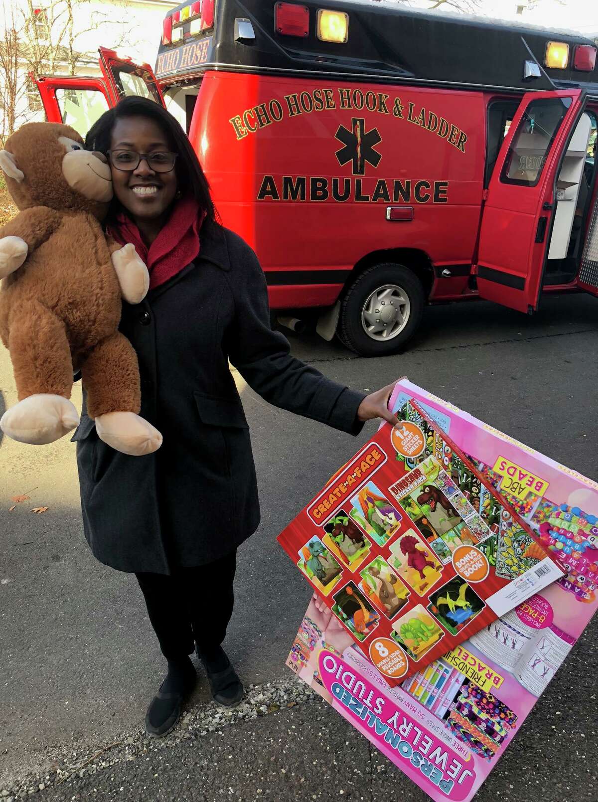 TEAM, Inc. Development and Community Manager Lisa Savoie helps deliver donated toys to the organization's Toys 4 Kids holiday toy store on Thursday.