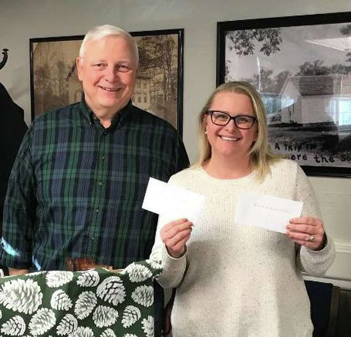 Tashua Knolls Senior Men's Club President Frank Chudy presents two $500 checks to Michele Jakab, the Trumbull Senior Center Director. The checks to Trumbull Senior Center and the Social Center were in addition to $420 presented earlier to the Center from the TKSMC members as part of its annual Holiday contributions.
