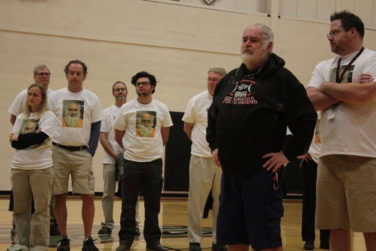 RCHS staff stands next to Scharlow, wearing t-shirts with his face on it. The t-shirts were made to raise money for Katie's Kloset, an organization created in honor of his daughter, who died of cancer in 2012. (Courtesy photo)