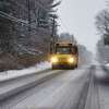 A school bus is driven along a snow covered road on Tuesday, Dec. 17, 2019, in Loudonville, N.Y. Some school districts were delayed or canceled while others remained open. (Paul Buckowski/Times Union)