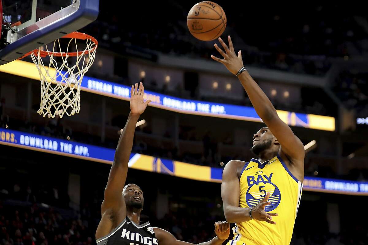 Golden State Warriors forward Kevon Looney (5) shoots against Sacramento Kings forward Harrison Barnes (40) during the second half of an NBA basketball game in San Francisco, Sunday, Dec. 15, 2019. (AP Photo/Jed Jacobsohn)