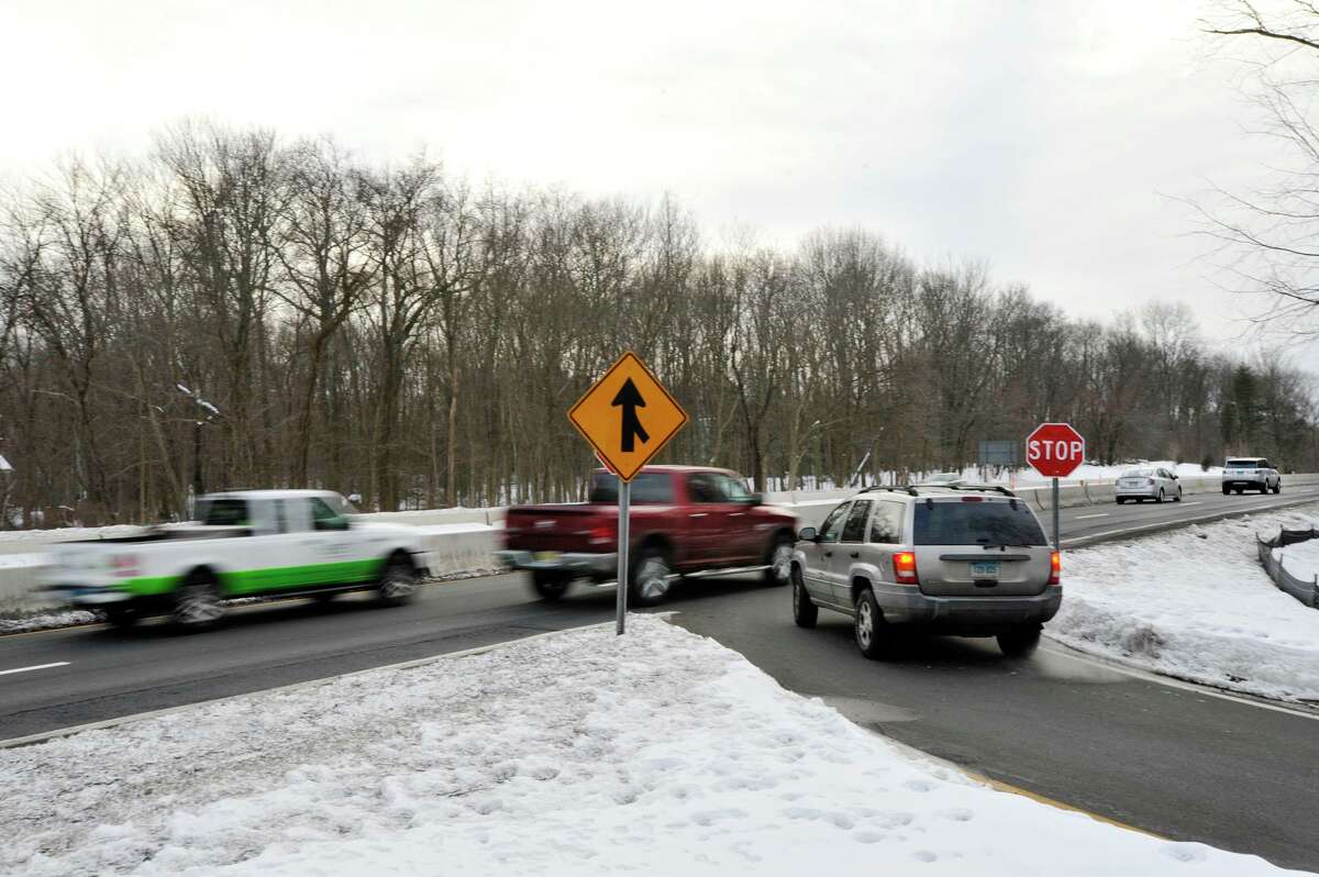 Traffic speeds along the southbound side of the Merritt Parkway as a vehicle attempts to enter at Den Road in Stamford.