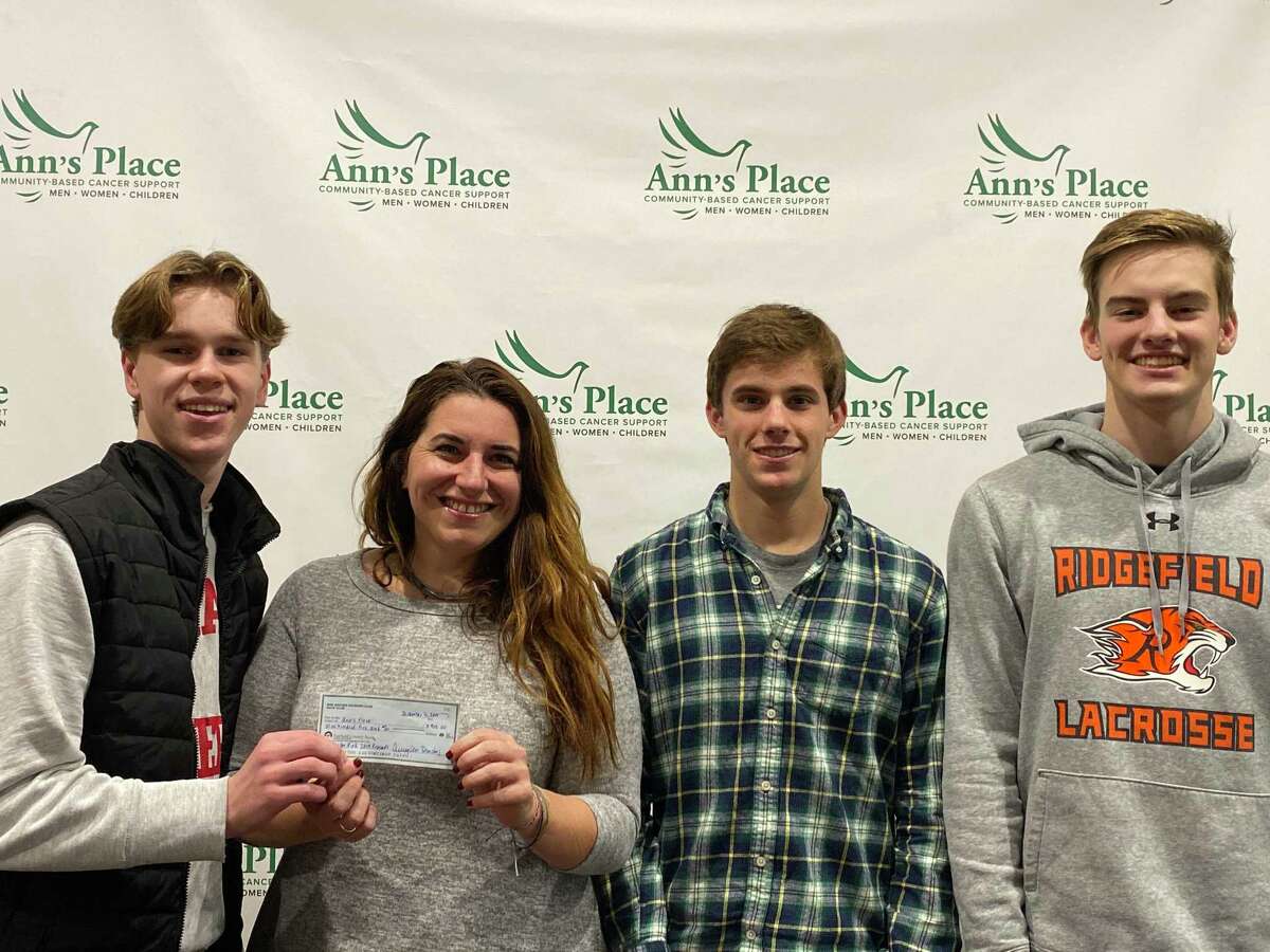 The captains of the Ridgefield High School boys soccer team presented a check for $905 to Ann's Place earlier this month. The money was money raised by the RHS Boys Soccer Program during their Play for Pink efforts this season. Pictured, from left to right: Ben Ragland, Rebekah Harriman-Stites of Ann's Place, Tim Vanni and Ray Dearth. Ann's Place is a tremendous local resource for support and guidance for patients and their families in a journey with cancer.